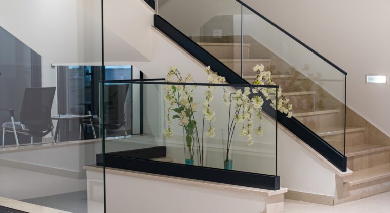 white interior with glass fence and stairs